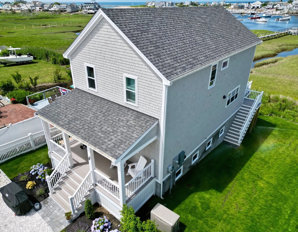 A beautifully renovated coastal home with a new roof, siding, and deck, representing D&G Exteriors' expert craftsmanship in Malden, MA.