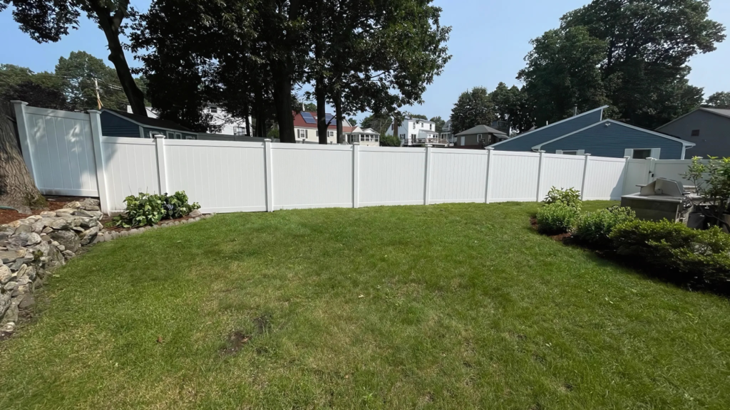 Secure white vinyl fence installed by D&G Exteriors in Malden, MA