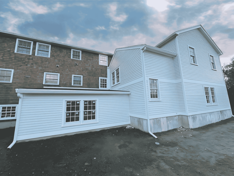 Freshly installed white siding on a renovated home, showcasing quality craftsmanship by D&G Exteriors