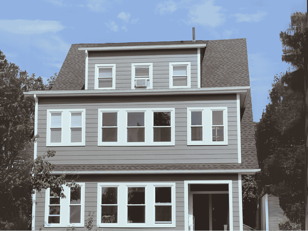 Newly installed white-framed windows on a residential home, improving energy efficiency and aesthetic appeal.