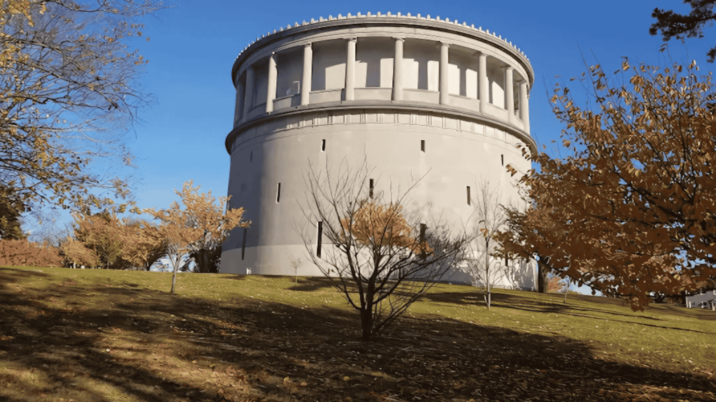 A historic circular structure in Arlington, MA, with autumn trees. D&G Exteriors is proud to serve the local community with roofing solutions.