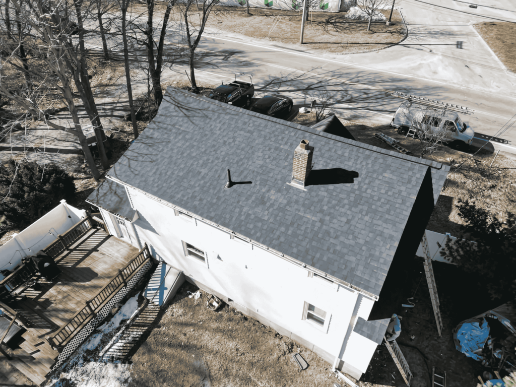 A newly installed asphalt shingle roof on a suburban home by D&G Exteriors, a trusted roofing company in Plymouth County.