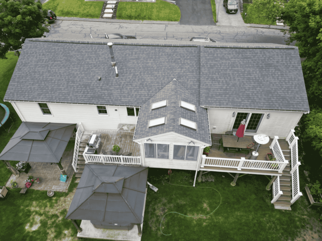 Aerial view of a well-installed residential roof by D&G Exteriors, providing roofing services in Plymouth County.