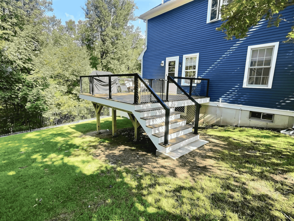 A well-constructed deck with black railing, perfect for outdoor gatherings in Lynn, MA.