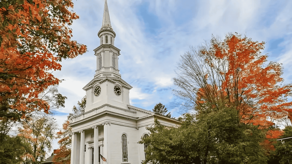 A beautiful church in Lexington, MA, surrounded by fall foliage. D&G Exteriors provides reliable roofing services in the area.