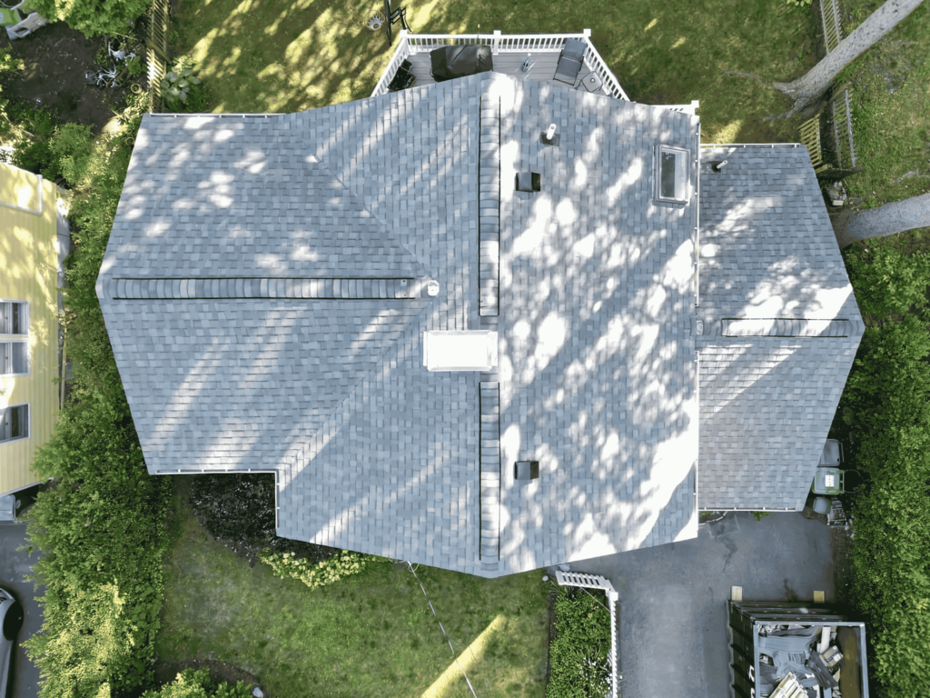 Top-down view of a professionally replaced roof in Gloucester, MA, completed by D&G Exteriors.