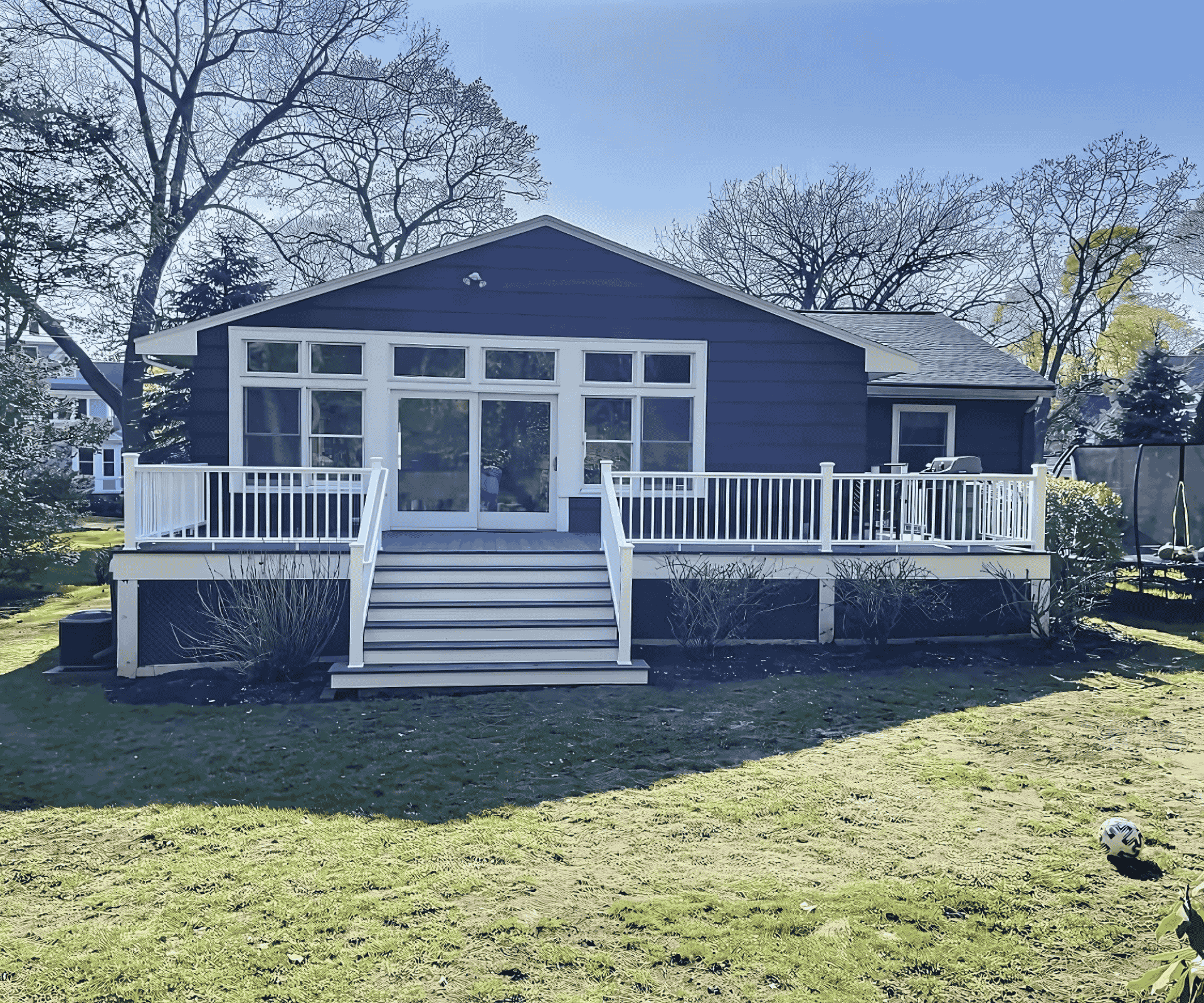 A newly built outdoor deck with white railings in Salem, MA, constructed by D&G Exteriors.
