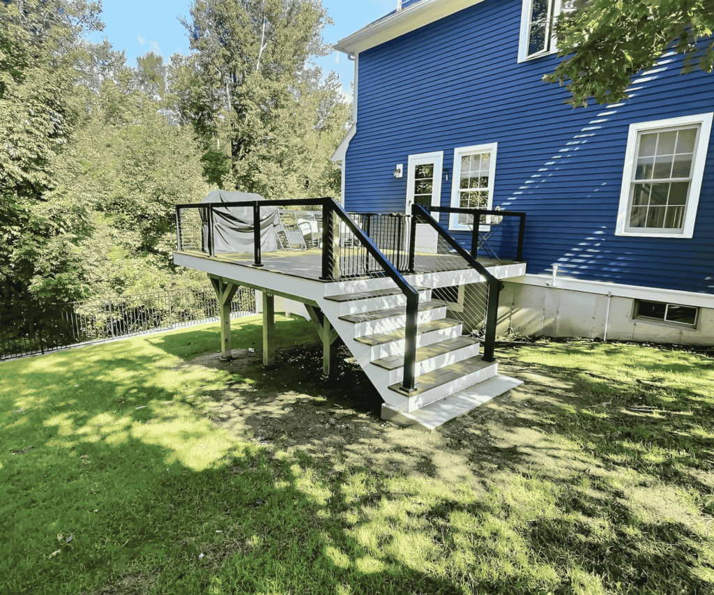 Beautiful custom-built deck with sturdy railings in Gloucester, MA by D&G Exteriors.